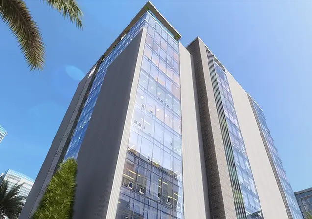 Impressive low-angle view of a modern glass tower, a completed landmark project by Maqam for Urban Development.